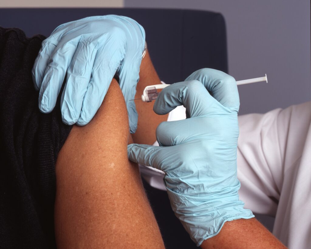 A nurse administers a vaccine