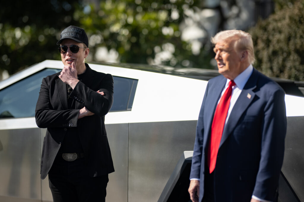 Elon Musk stands with President Trump on the White House's South Lawn beside a Tesla Cybertruck. Musk and Treasury Secretary Scott Bessent got into a shouting match outside the Oval Office recently, culminating a dispute between the two over leadership of the IRS.