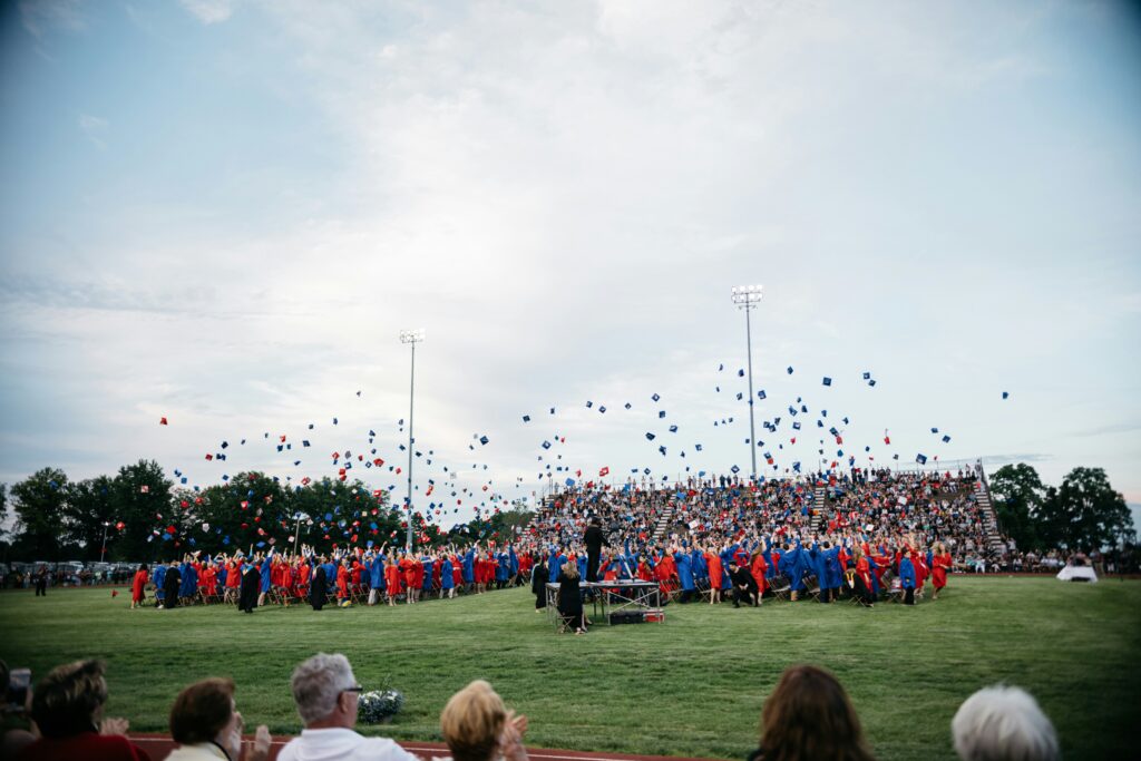 Students throw caps into the air to mark their graduation from high school in Philadelphia. The Trump administration recently cut off federal funds that support mental-health services in K-12 schools.